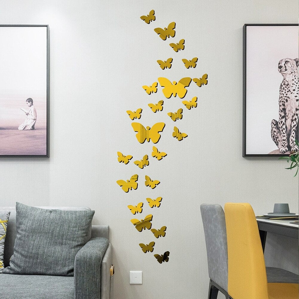 Golden mirrored 3D butterfly wall stickers displayed in a living room