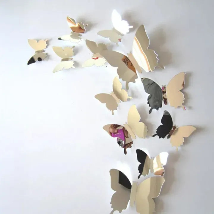 Silver reflective butterfly stickers on light wall