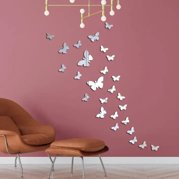 Silver butterfly mirror wall stickers arranged on pink wall