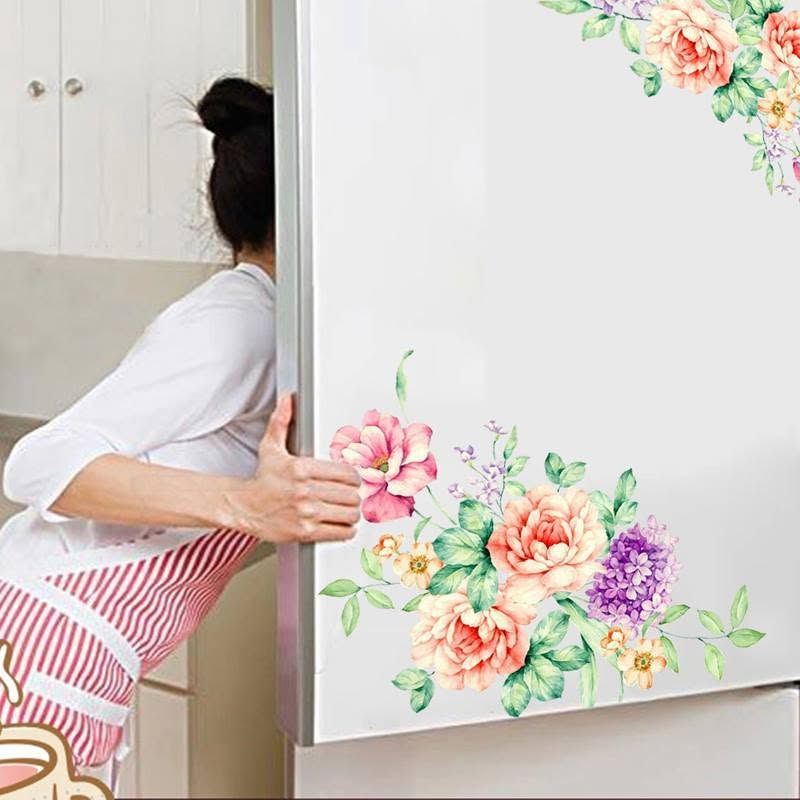 Peach and pink flowers with purple blossom foliage decorate the corners of a white refrigerator door