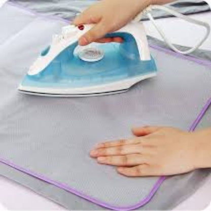 Grey mesh sheet under steam iron while pressing